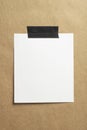 Blank polaroid photo frame with soft shadows and black scotch tape on craft cardboard paper background as template for graphic Royalty Free Stock Photo