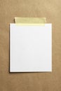 Blank polaroid photo frame with soft shadows and yellow scotch tape on craft cardboard paper background as template for graphic Royalty Free Stock Photo