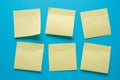 Blank post-it notes stuck in order on a blue background Royalty Free Stock Photo