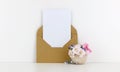 Blank postcard mockup with craft paper envelope and white flowers Royalty Free Stock Photo