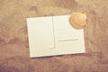 Blank postcard and sea shell in hot beach sand Royalty Free Stock Photo