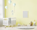 Blank poster frame mock up on yellow wall in nursery room interior background with baby bedding, soft toys, balloons, 3d rendering Royalty Free Stock Photo