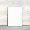 Blank Poster paper standing next to a white brick wall Royalty Free Stock Photo