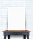 blank poster on vintage wooden table at brick tiles wall,Template for add your content