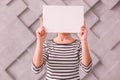 Woman covering her face with a blank poster Royalty Free Stock Photo