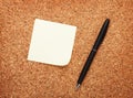 Blank postit note on cork notice board Royalty Free Stock Photo