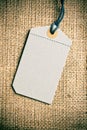 Blank price tag label on burlap background Royalty Free Stock Photo