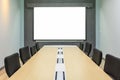 Blank projection screen in meeting room with conference table Royalty Free Stock Photo