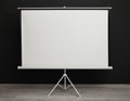 Blank projection screen near black wall. Space for design