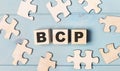 Blank puzzles and wooden cubes with the text BCP Business Continuity Plan lie on a light blue background Royalty Free Stock Photo