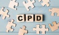 Blank puzzles and wooden cubes with the text CPD Continuing Professional Development lie on a light blue background Royalty Free Stock Photo