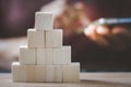 Blank stack of wooden cubes with blurred people touched smartphone for business design , technology, online promotion, graphics