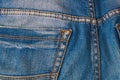Blank real leather jeans label sewed on old worn blue jeans Royalty Free Stock Photo