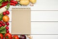 Blank recipe book and different ingredients on white wooden table, flat lay. Space for text Royalty Free Stock Photo