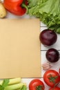 Blank recipe book and different ingredients on white wooden table, flat lay. Space for text Royalty Free Stock Photo