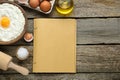 Blank recipe book and different ingredients on wooden table, flat lay. Space for text Royalty Free Stock Photo