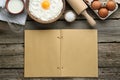 Blank recipe book and different ingredients on wooden table, flat lay. Space for text Royalty Free Stock Photo