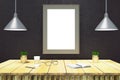 Blank rectangle picture frame on black wall with wooden table wi Royalty Free Stock Photo