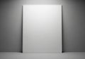 A blank, rectangular canvas stands vertically against a gray wall Royalty Free Stock Photo