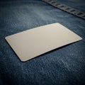 A blank rectangular paper card is placed on dark blue denim fabric, positioned at an Royalty Free Stock Photo