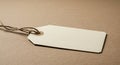 A blank, rectangular paper tag lies on a textured brown surface. The tag is light beige Royalty Free Stock Photo