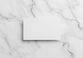 A blank rectangular white card centered on a smooth, elegant white marble surface with gray Royalty Free Stock Photo