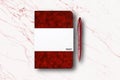 Blank red paper notebook or pocket book and a pen on white marble table background Royalty Free Stock Photo