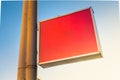 Blank red plastic signboard on post. Empty mounted sign plate mock up. Clear outdoor plexiglass signage for hotel or store info Royalty Free Stock Photo