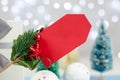 Blank red tag on a Christmas background. Christmas and New Year discounts and sales