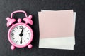 The Blank reminder note and alarm clock on black background, space for text Royalty Free Stock Photo
