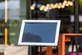 Blank restaurant shop sign or menu board near the entrance to restaurant. Cafe menu on the street. Blackboard sign mockup in front Royalty Free Stock Photo