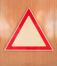 Blank road danger sign with wood background