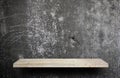 Blank stone display shelf on crack cement wall Royalty Free Stock Photo