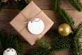 Blank round Christmas gift tag mockup with present box, product label mockup, with natural fir tree branch Royalty Free Stock Photo