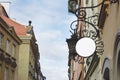 Blank round signboard, hanging from wrought iron bracket Royalty Free Stock Photo