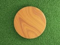 Blank round wooden platform podium on grass field top view.