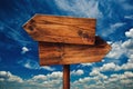 Blank Rustic Opposite Direction Wooden Sign Against Clouds