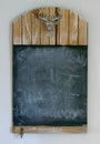 Blank rustic wooden chalkboard hanging on a wall Royalty Free Stock Photo