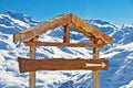 Blank rustic wooden sign, snowy mountain