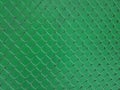 Blank rusty Metal Fence net mesh on dark green plain background Royalty Free Stock Photo