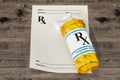 Blank RX prescription form with medical bottle drugs on the wood