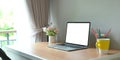 Blank screen computer laptop is putting on a wooden working desk in the living room Royalty Free Stock Photo