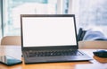 Blank screen laptop on a wooden desk, blur winddow background Royalty Free Stock Photo
