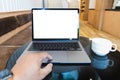 Blank screen laptop computer modern man use room laptop with blank white desktop screen with coffee cup on wooden table in cafe