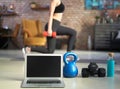Blank screen laptop and fitness equipments. Concepts about online workout program, fitness video, home exercise