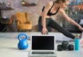 Blank screen laptop and fitness equipments at home. Concepts about online workout program, fitness video program, home workout