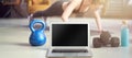 Blank screen laptop with fitness equipments at home. Concepts about online workout program, fitness video, home workout