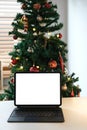 Blank screen laptop template with copy space. Home office desk table workspace. Modern interior design decorated with Christmas