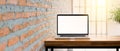 Blank screen laptop on wooden desk Royalty Free Stock Photo