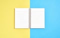 Blank screen notebook blank and pen placed on pastel yellow and blue background. Royalty Free Stock Photo